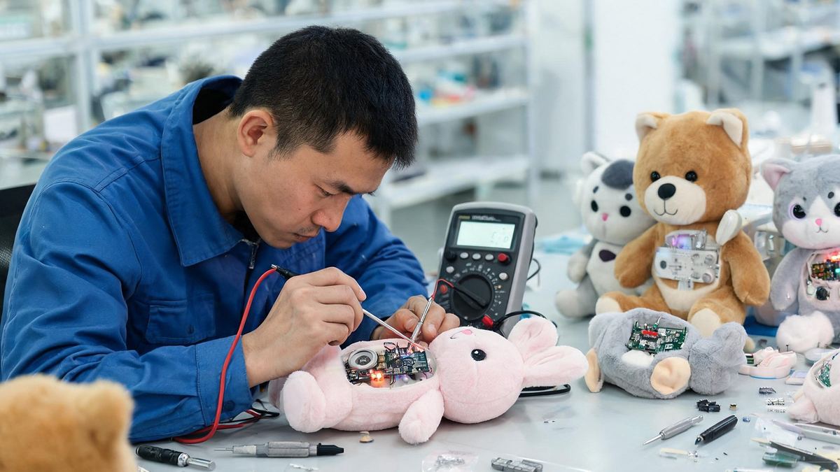 Technician testing the sound and light module of an interactive plush toy